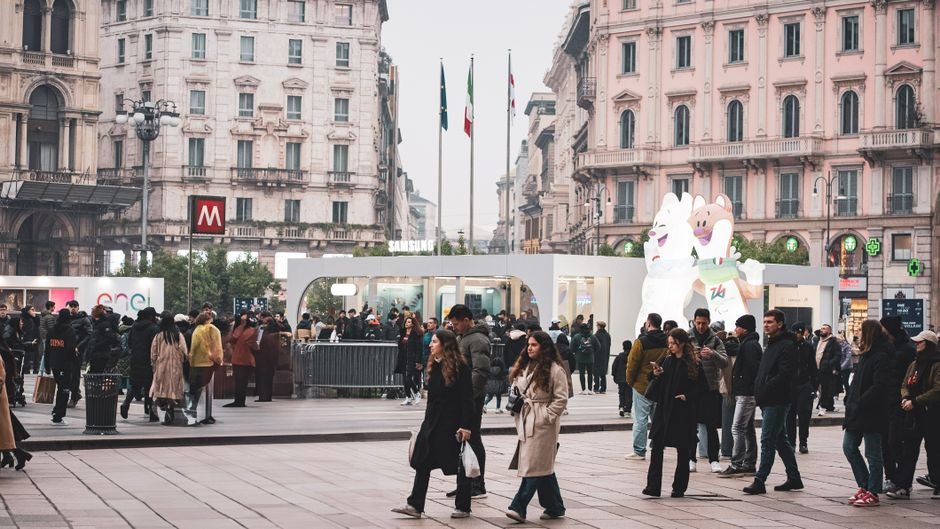 A bustling scene in Milan's historic district with people enjoying outdoor activities in Piazza during winter.